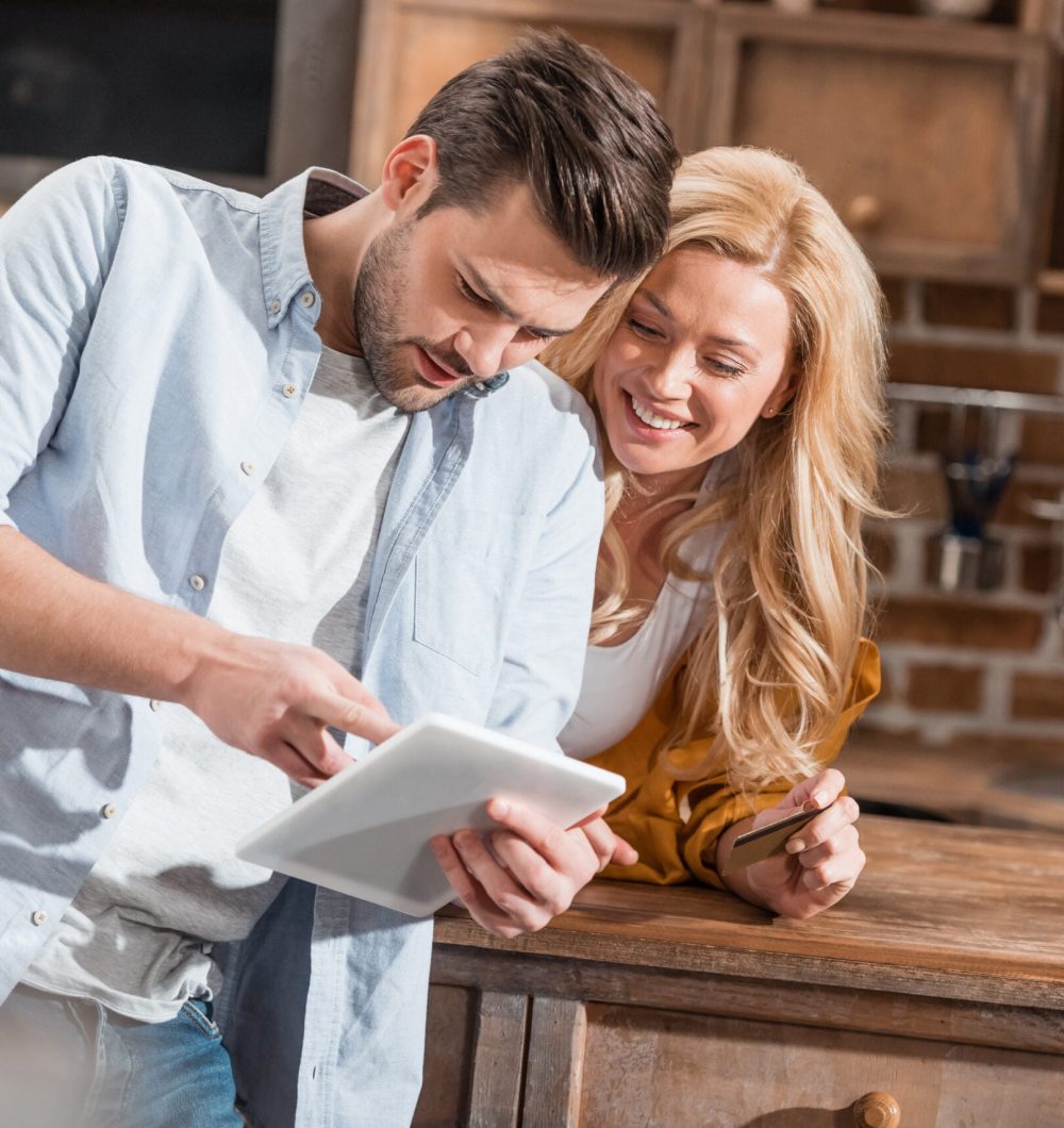 young-couple-making-e-shopping-with-tablet-on-kitc-2022-11-02-02-48-52-utc-scaled.jpg